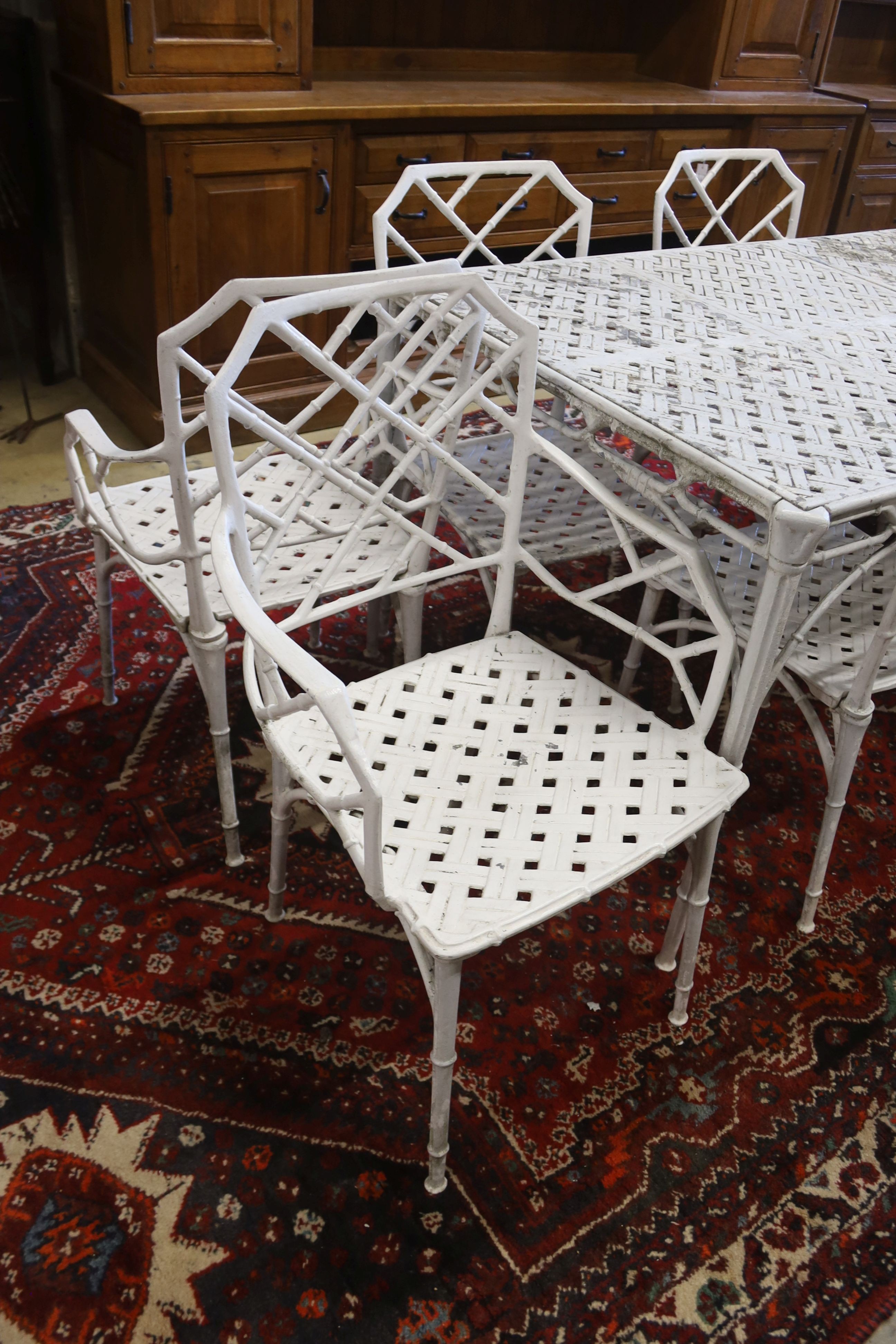 A painted aluminium faux bamboo rectangular garden table, length 130cm, depth 88cm, height 71cm and six chairs